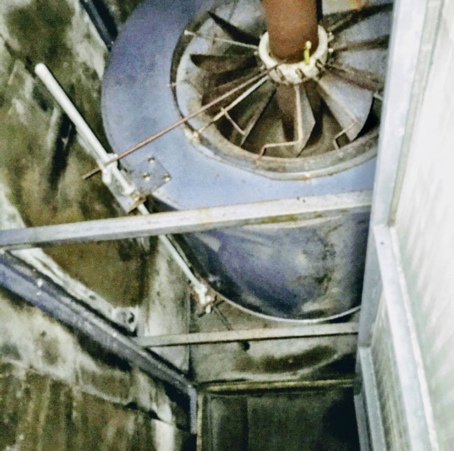 Blower motor undergoing cleaning in an HVAC system.