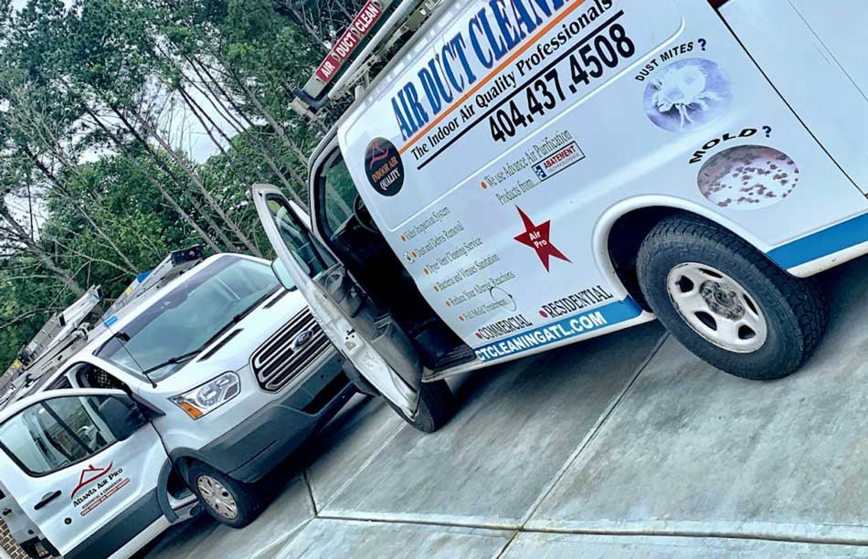 Air Duct Cleaners service vans parked on a driveway