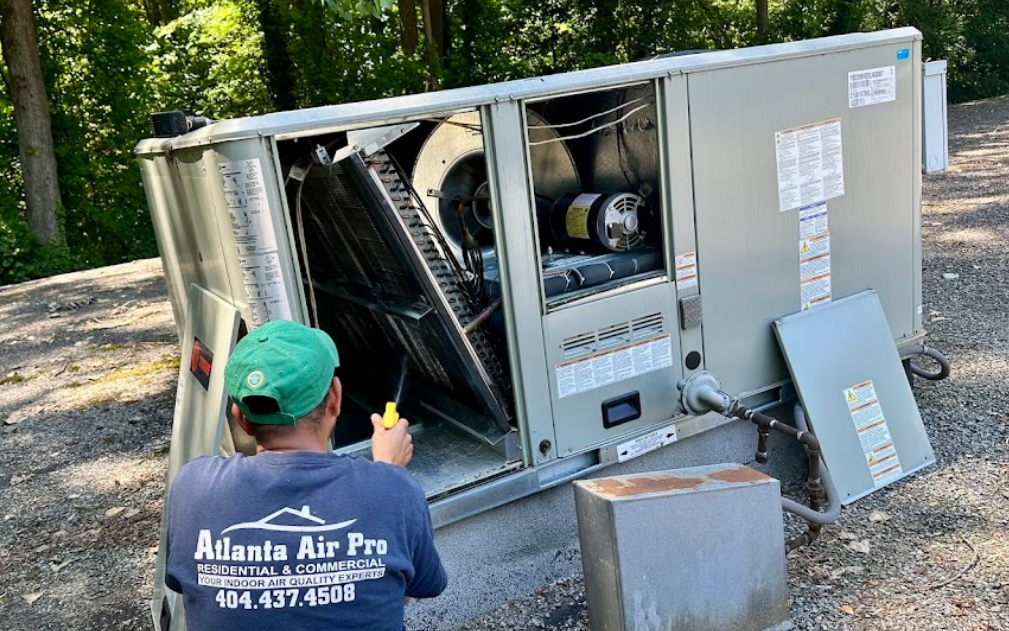 Atlanta Air Pro technician inspecting an outdoor HVAC unit