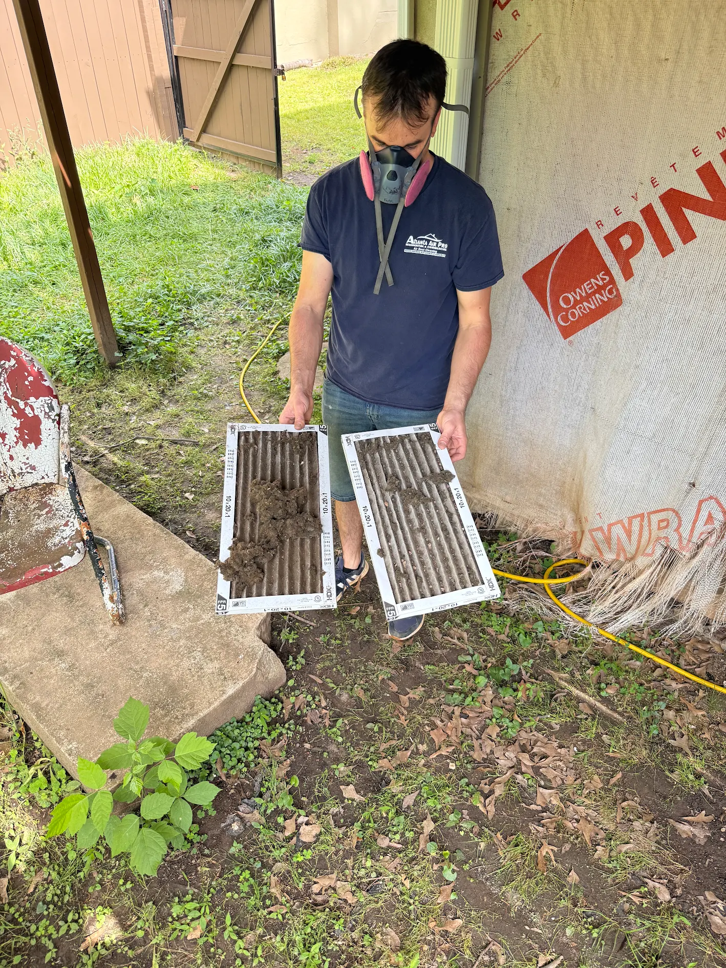 atlanta air pro technician holding dirty hvac filters