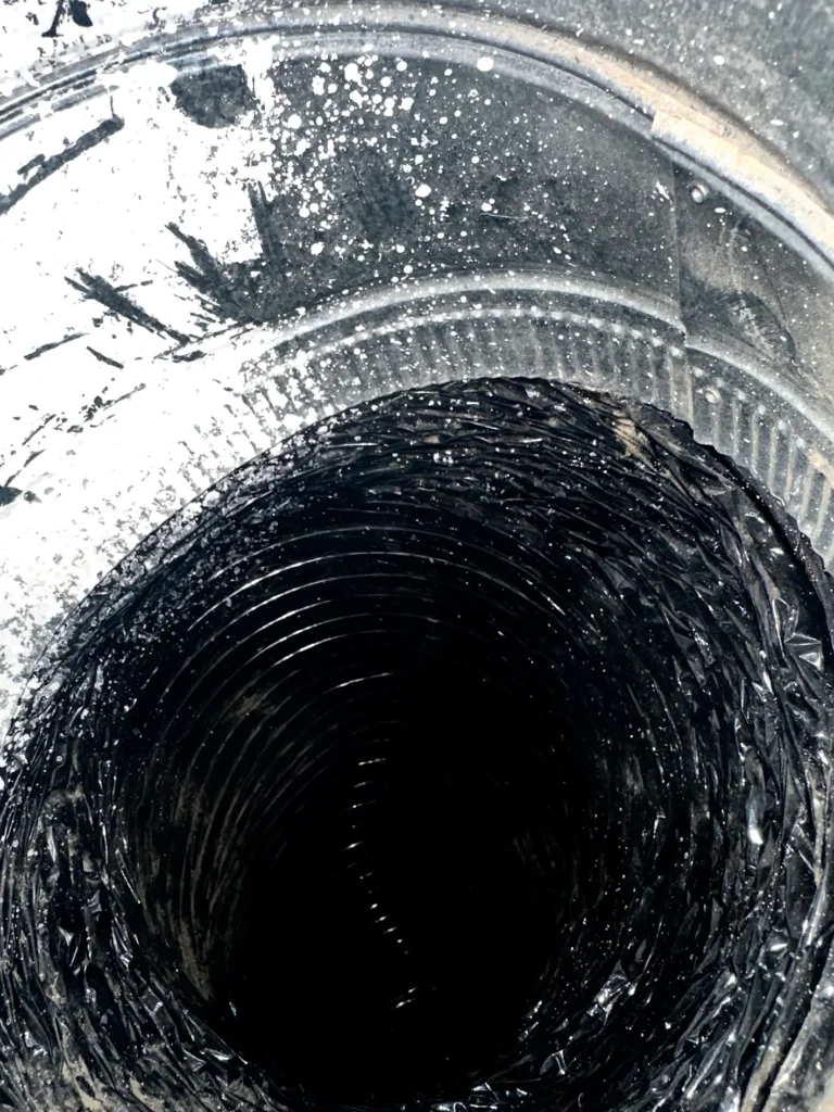 Interior of a flexible residential air duct after professional cleaning removed visible dust and debris