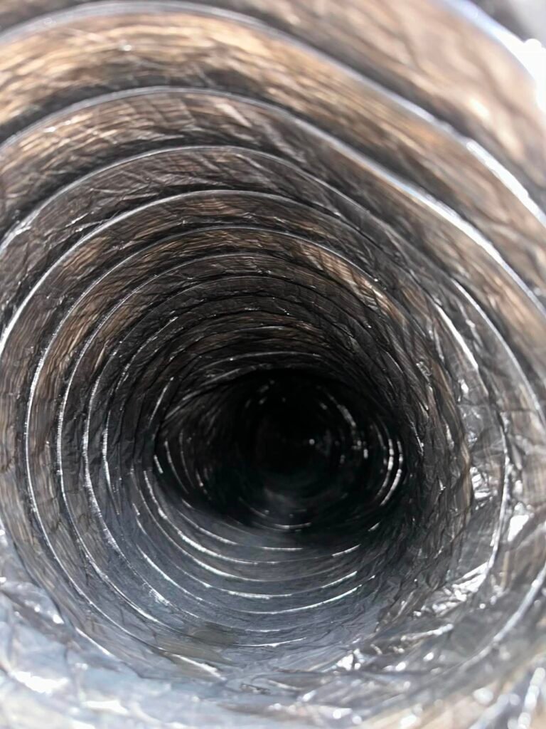 Metallic flexible air duct after deep cleaning removed the heavy dust and debris buildup