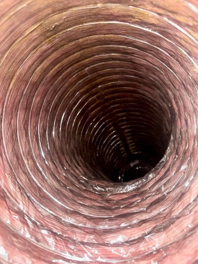 Metallic flexible air duct after professional cleaning removed the visible dust and debris